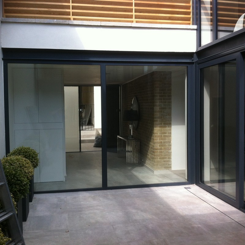 Floor-to-ceiling sliding doors opening to courtyard in Norbury