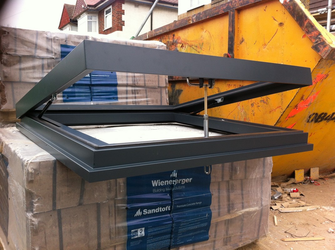 Opening flat roof skylight in anthracite grey installed in Norbury